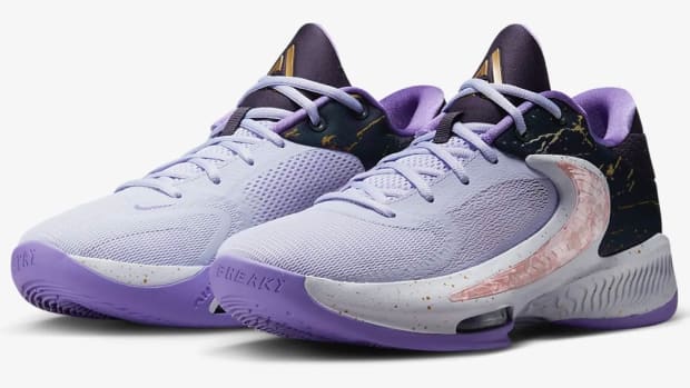 View of purple and black Nike Zoom Freak shoes.